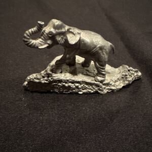 Vintage miniature pewter elephant on a platform
